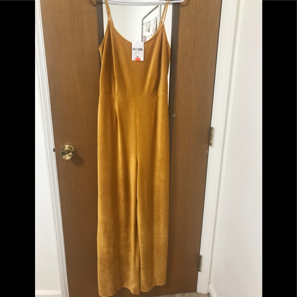 Brand new mustard jumpsuit. Size Medium